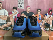 Front view of the pair showing black laces, blue perforated toe panels, and glossy black overlays.