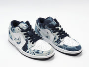 Three-quarter view of the paired low-top sneakers with washed denim-look panels and white side sections.