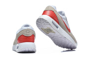 Rear and outsole views of the Nike Air Max Verse sneakers, showing the red heel panel and patterned tread.