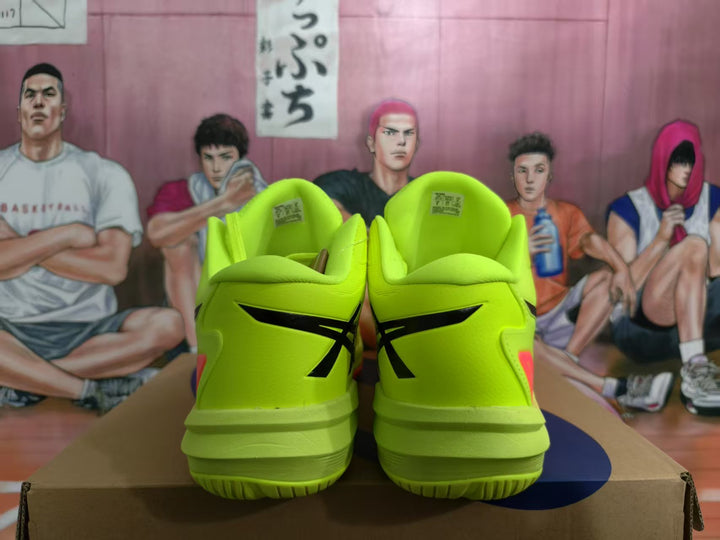 Rear view of neon yellow ASICS basketball sneakers with black branding and red heel accents.
