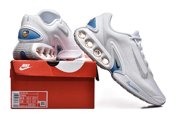 White and blue Nike Air Max DN sneakers displayed with a red shoebox; the box label shows EU 42.