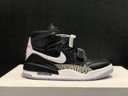 Full side profile of a black and white high-top sneaker with a white Swoosh and elephant-print midsole panel.