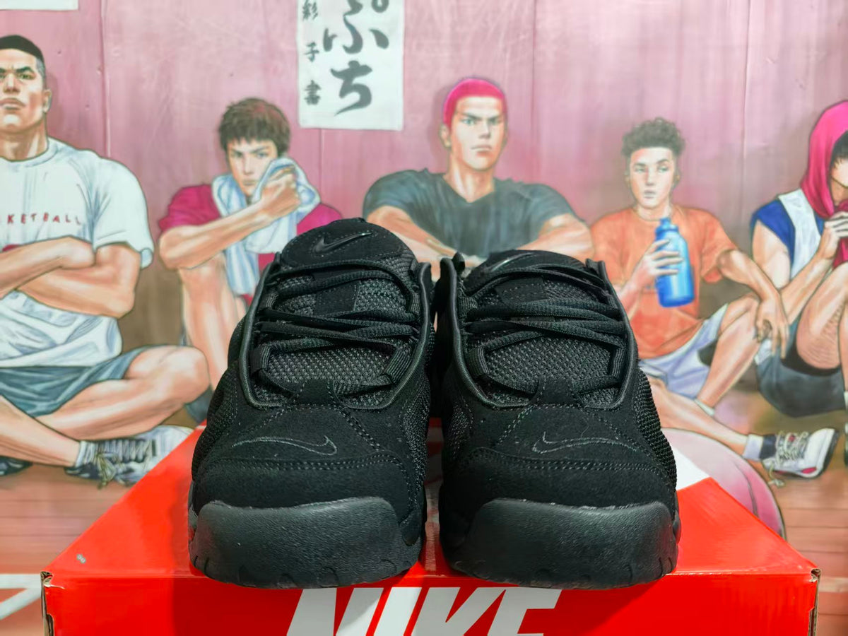 Front view of black Nike basketball sneakers with black laces and a matching sole