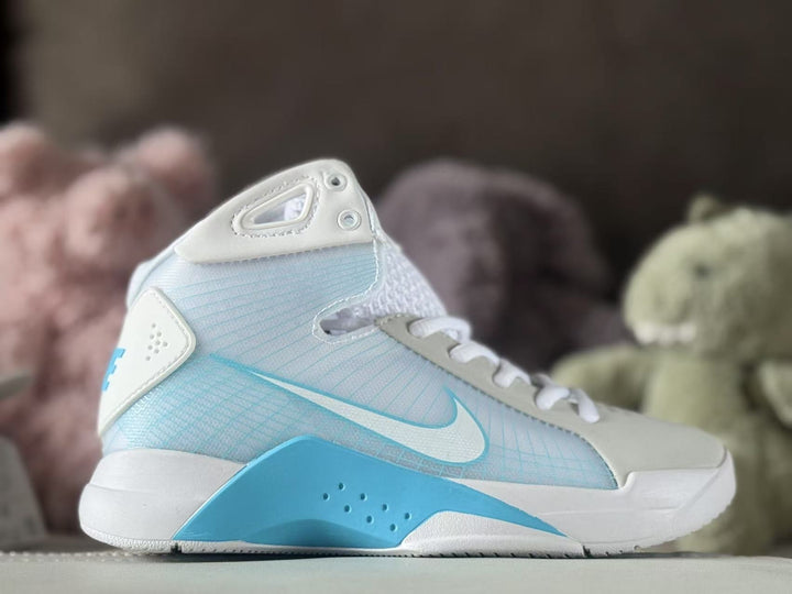 Side view of white and pale blue Nike HD2008 kids high-top sneakers with bright blue accents.
