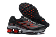 Nike Shox Ride 2 sneakers showing the side profile and outsole with red circular details.