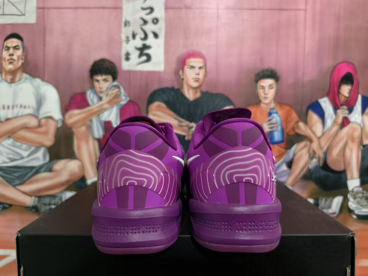 Rear view of a pair of purple Nike basketball sneakers showing heel artwork, padded collars, and purple outsoles.