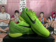 Angled view showing the green textured upper, black logos, laces, padded collar, and sole construction.