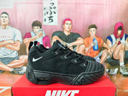 Side profile of a black Nike sneaker with lace-up closure and sculpted sole.