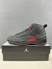 Single black high-top sneaker shown in profile with red lace hardware and a red side accent.