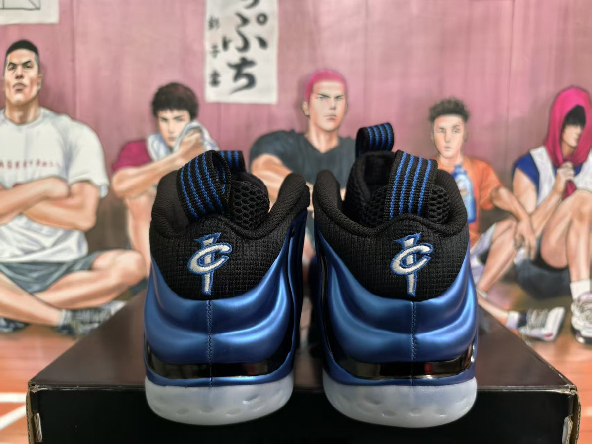 Rear view of blue and black high-top sneakers with heel logos and light-colored outsoles.