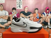 Side view showing the black Swoosh and white upper of a Nike basketball shoe