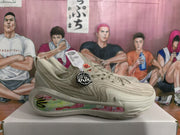 Side profile of a beige sneaker with a floral-patterned midsole panel and textured upper.