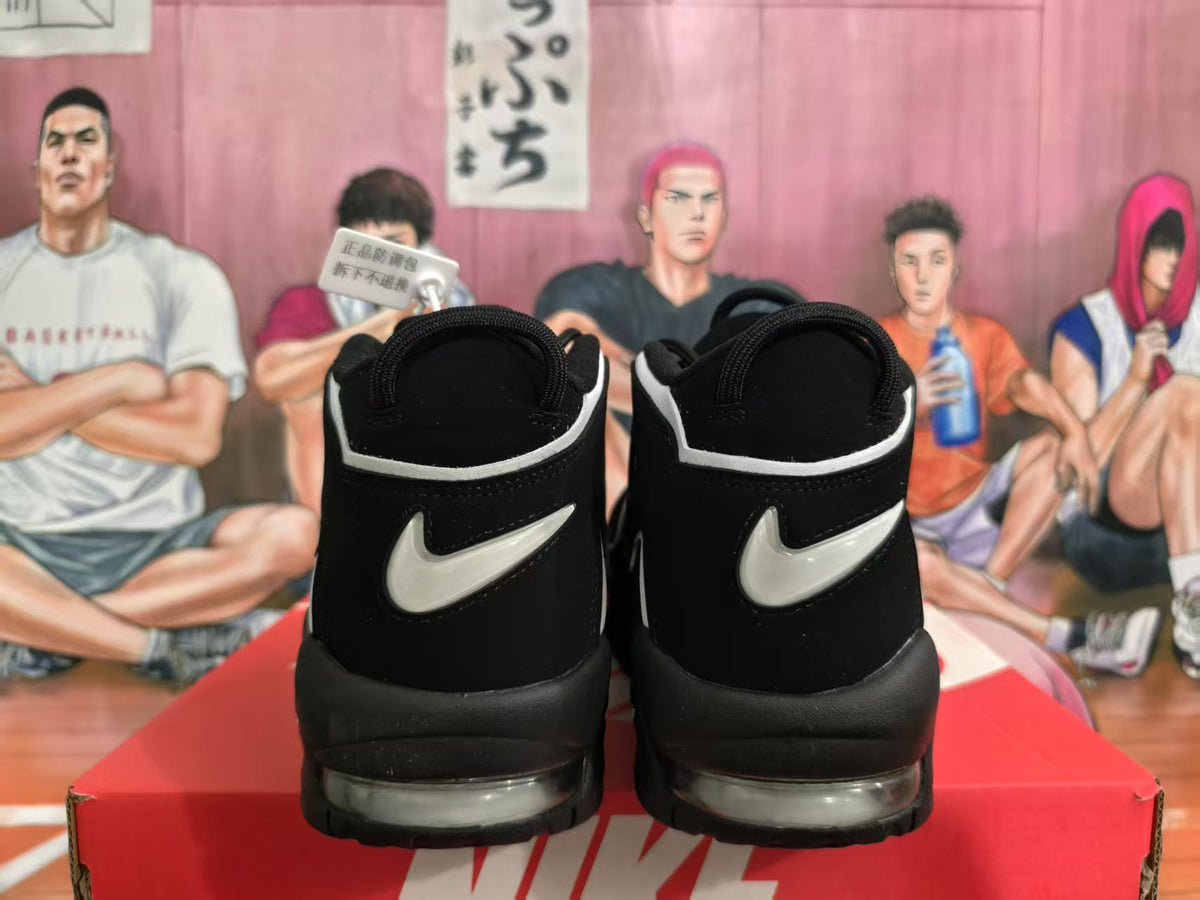 Rear view of black and white Nike basketball sneakers showing contrasting Swoosh details and visible sole cushioning.