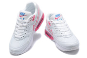 Front views of white Nike Air Max BW sneakers with pink and blue tongue details.
