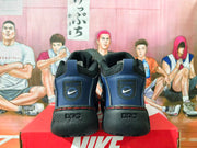 Rear view of the sneakers showing blue heel panels, logo patches, and black sculpted soles.