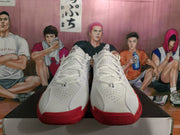Front view of white and red Nike sneakers showing perforated toe boxes, white laces, and black tongue branding.