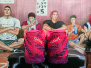 Rear view of the purple-red Nike basketball sneakers showing patterned heel panels and white heel lettering.