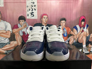 Front view of navy and white sneakers showing white laces and translucent-looking outsoles.