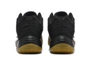 Rear view of the pair of black sneakers, showing layered heel panels and gum-colored outsole sections.