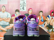 Rear view of the purple basketball sneakers showing Kobe emblems, patterned heel panels, and translucent outsole sections.