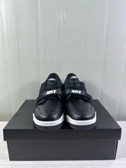 Front view of the sneakers showing perforated black toe boxes, black straps, and white midsoles.