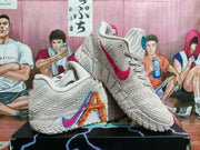 Side view showing the light grey textured upper and multicolor graphic