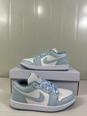 Side profile of the low-top sneakers highlighting the blue-grey overlays and white panels.