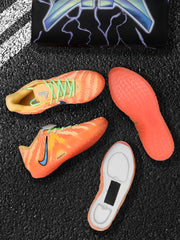 Orange-red Nike sneakers shown from above and below, highlighting the green laces and textured outsole.