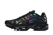 Side profile of a black Nike Air Max Plus sneaker with multicolor overlays and visible air units.