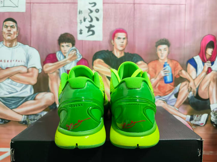 Rear view of bright green Nike basketball shoes with molded heel details and lime soles.