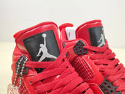 Close-up of the black tongue panels, Jordan-style logos, red laces, and black lace hardware.