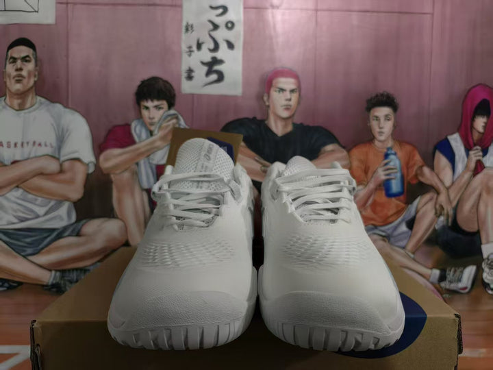 Front view of white ASICS basketball shoes with textured uppers and lace-up closure.