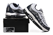 White and dark-accent Nike Air Max 97 OG sneakers displayed with a shoe box; the box label shows sample size EU 42.5.