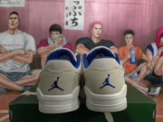 Rear view of off-white low-top sneakers with blue lining, blue heel logos, and white soles.