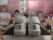 Rear view of the white and grey basketball shoes with signature-style heel details.