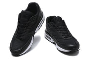 Pair of black Nike Air Max sneakers shown from the front.
