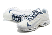 Angled view of white sneakers with navy laces and translucent side panels