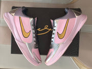 Top-down view of the pair showing the pink panels, metallic silver overlays and gold Swooshes.