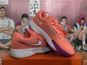 Angled view of the pink and purple Nike basketball sneakers with visible side swooshes and textured uppers.