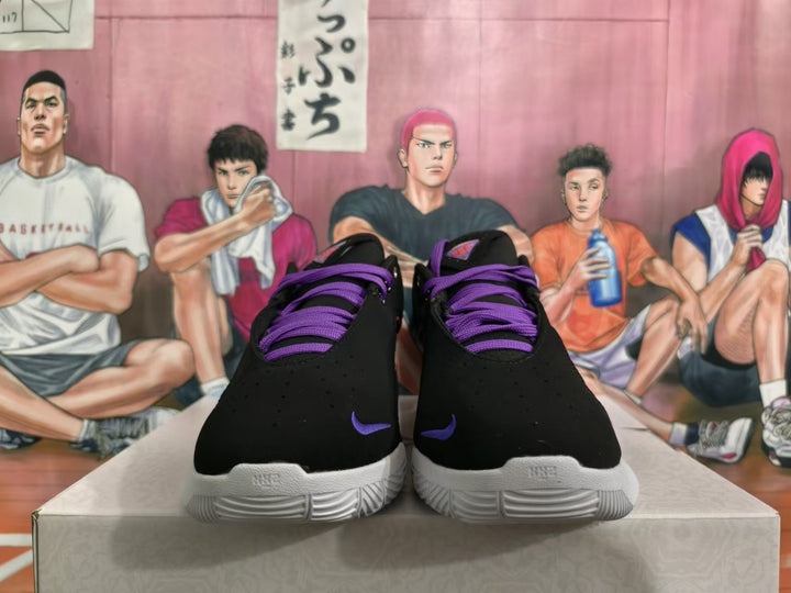 Front view of black Nike basketball shoes with purple laces and white soles