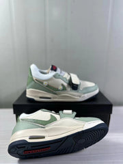 Angled view showing the mint green and white sneaker upper, forefoot strap, and dark navy outsole.