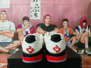 Rear view of white sneakers with black heel details and red 23 markings.