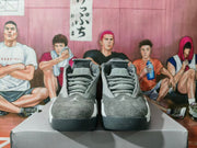Front view of the gray and white high-top sneakers showing the laces, perforated tongues, padded collars, and toe panels.