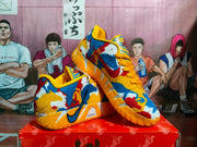 Pair of orange and multicolor Nike basketball sneakers displayed on a red shoebox.