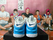 Rear view showing blue heel panels, white heel overlays, and dark blue Nike swooshes.