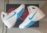 Angled overhead product view showing both white and Carolina blue Nike Hyperdunk sneakers on a box.