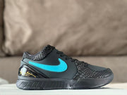 Side profile of a black low-top basketball sneaker with a turquoise Swoosh, textured collar and toe overlays, and a glossy heel section.