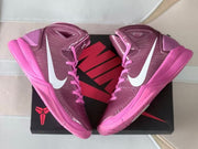 Pair of high-top basketball shoes displayed over a black and red shoe box.