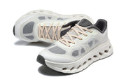 Pair of white and gray On Cloudtilt Remix sneakers in an angled top view.