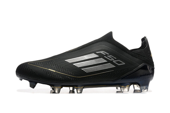 Side view of a black adidas F50 laceless soccer cleat with silver stripes, gold accents, and a studded outsole.